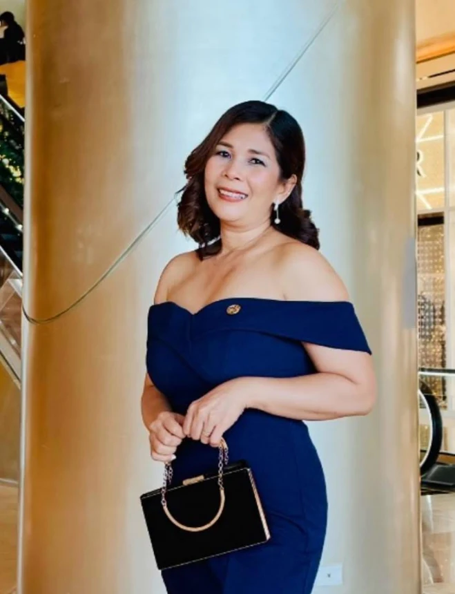 A portrait supplied by JAN of its founder in a navy evening dress.